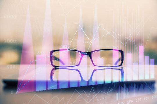 Financial graph hologram with glasses on the table background. Concept of business. Double exposure. - Powered by Adobe