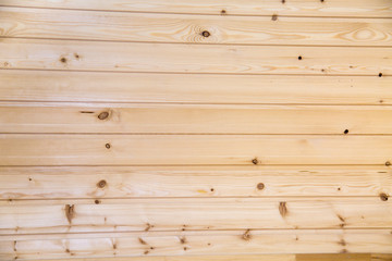 Fototapeta premium Background of planed coniferous planks with a beautiful pattern of trees with knots. Design backgrounds texture construction.