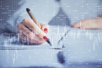 Double exposure of woman's hands making notes with forex graph hologram. Concept stock market...