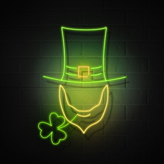 A hat with a beard without a face and a shamrock of clover. Glowing neon symbols of the holiday of St. Patrick on the background of a brick wall.