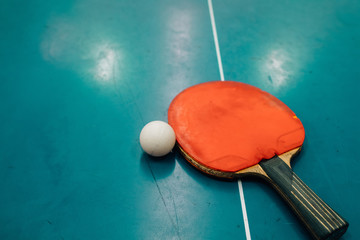 High Angle View Of Table Tennis Racket And Ball On Table