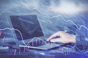 Multi exposure of stock market chart with man working on computer on background. Concept of financial analysis.