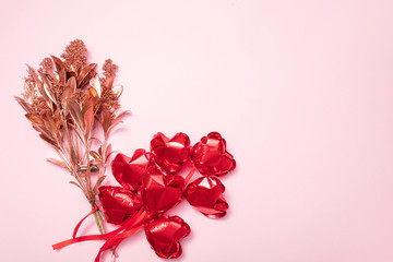 Valentine Day background with red balloons, flowers, confetti, hearts on pink background. Abstract flatlay