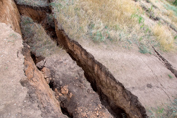 landslide in an environmentally hazardous area large crack in ground descent of large layers of...