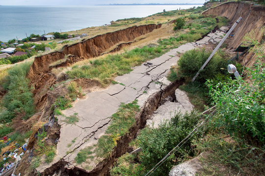 the sunk asphalt road after a landslide, natural disaster landslide of soil with an asphalt road off the coast.