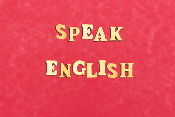 forming speak english with wooden letters 