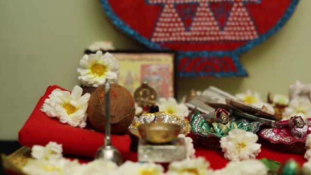 Indian wedding ceremony : Lord sculpture and  decorative coper kalash with green leaf and coconut 