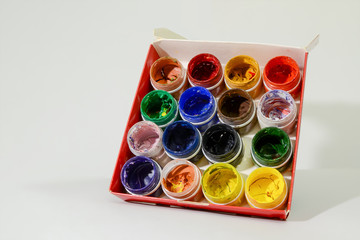 Cans of paint art. Dirty and used gouache or acrylic paint.