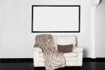 Interior design concept. White modern sofa at white wall and black floor in living room.