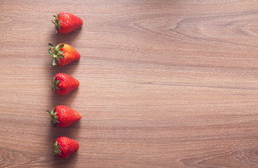 fresh strawberries on the brown wooden table