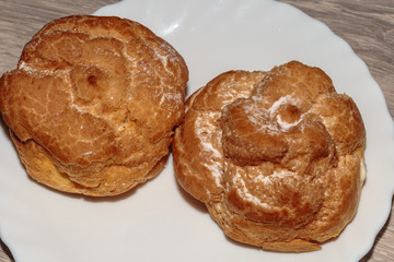 Fresh eclair with whipped cream.