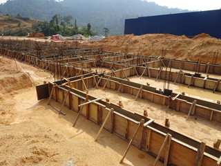 Building ground beam under construction using temporary timber plywood at the site. Reinforced by the reinforcement steel to strengthen the structure.   