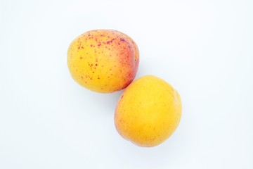 Tasty ripe beautiful apricots located on a white background