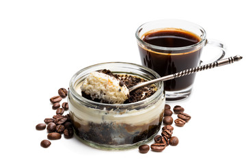 Layered creamy cappuccino cheesecakes in glass jar isolated on white