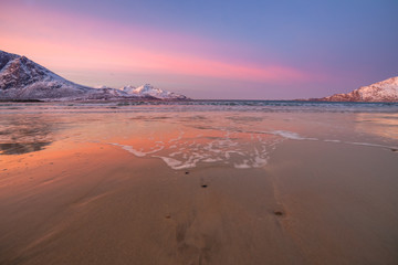 Amazing sunrise with amazing magenta color over sand beach. Tromso, Norway . Polar night. long shutter speed