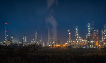 Obraz na płótnie Canvas Landscape of Oil and Gas Refinery Manufacturing Plant., Petrochemical or Chemical Distillation Process Buildings., Factory of Power and Energy Industrial at Twilight Sunset., Engineering Petroleum.