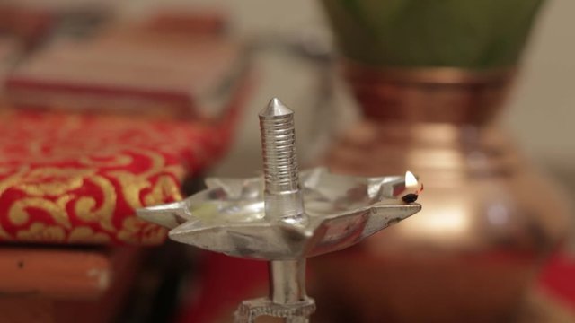 Indian wedding ceremony : Lord sculpture and  decorative coper kalash with green leaf and coconut 