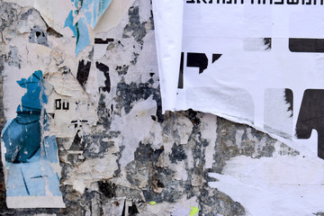 Ads, posters torn on advertising signs, written in Hebrew