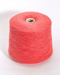 Green bobbin of yarn on a white background.Textile reel on isolated white background.