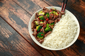 Homemade Beef and Broccoli with Rice on wooden table