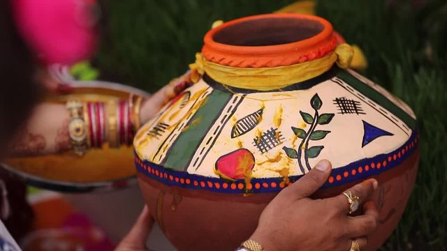 Traditional indian wedding ceremony in Hinduism :decorative pitchers in hand  