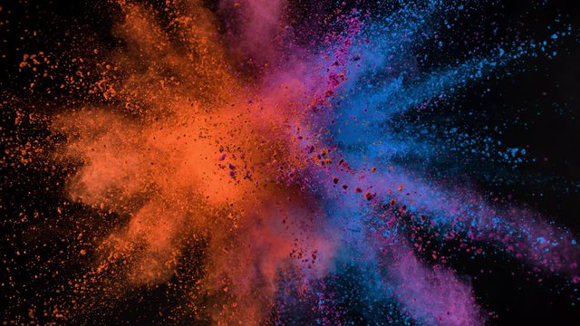 Super slow motion of coloured powder collision isolated on black background. Filmed on high speed cinema camera, 1000fps.
