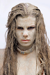 A young woman's face is covered with dirt and filth. Her hair is tangled in a mess. Her facial...