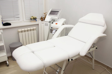 Fototapeta premium White equipment and a couch in a cosmetology cabinet for laser hair removal