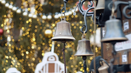 Closeup view of many beautiful old fashioned golden christmas bells hanging as new year
