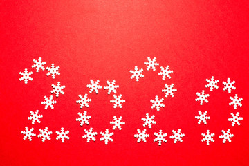 2020 inscription on a red background from decorative snowflakes. Happy New Year.