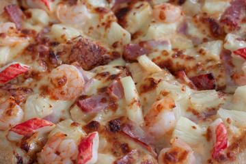 Closeup sliced seafood cocktail pizza homemade for background.
