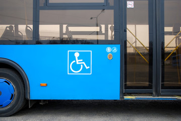 Disability and elderly person icon next to bus doors