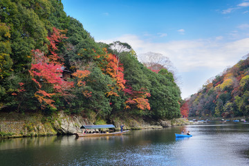 Kyoto, Japan - November 26, 2019: Traveler riding boat at Hozu river in Autumn season at Arashiyama area in Kyoto, Japan