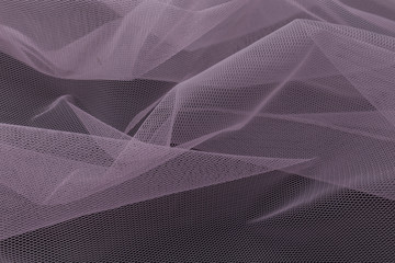 Beautiful close up of lila tulle fabric with textile texture background