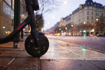 Electric scooter on a gray day with rain and traffic