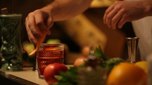 Barman finishing making cocktail.