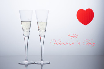 Valentine´s day composition .with two glasses of champagne and a red heart. San Valentine and Love concept.