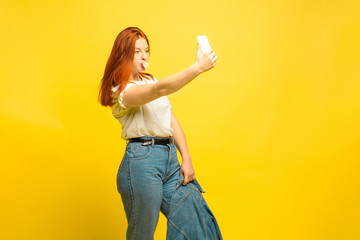 It's easier to be follower. Need minimum clothes for selfie. Caucasian woman's portrait on yellow...