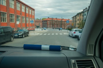 A folder lying on the dashboard of a car