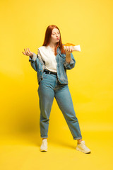 It's easier to be follower. Don't need to take photo with food. Caucasian woman's on yellow background. Beautiful female red hair model. Concept of human emotions, facial expression, sales, ad.