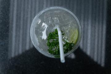 soda drink with lime and mint isolated on dark background