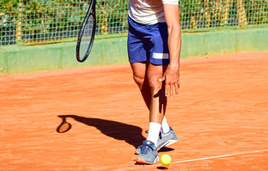 Fototapeta na wymiar Close up photo of professional tennis player with a racket and a tennis ball.