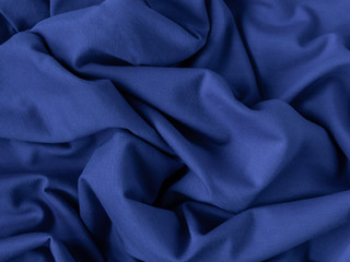 classic blue color of the year 2020. fabric texture, folds, closeup. selective focus