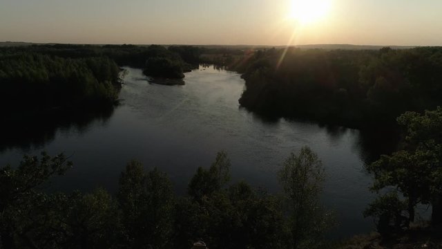 Guy and girl having fun at sunset. Aerial