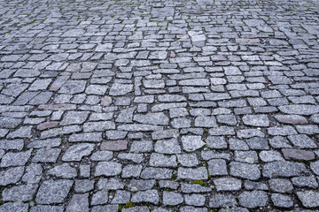 View of granite cobblestoned pavement background. Full frame of irregular cobbled street. Natural stone textured background