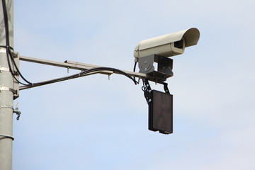 Highway road speed camera close up on a pole in Moscow street against the blue sky, car drivers mulct