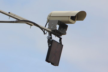 Highway speedcam control speed limit unit close up side view on a mast in Moscow on blue sky background