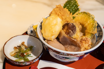 Japanese dish, Tendon or Mixed Tempura is consist of pork, egg and vegetables that have been battered and deep-fried topped on Gohan or Japanese rice served with pickled vegetable