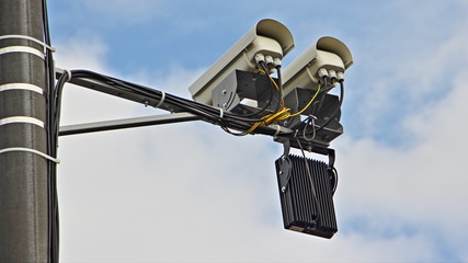 Obraz premium Twin highway road speed control camera close up back view on a mast in Moscow on blue sky background