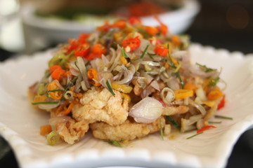 Spicy vegetables served on a plate. Consists of leeks, sprouts, garlic, onions and fried fat. Front View